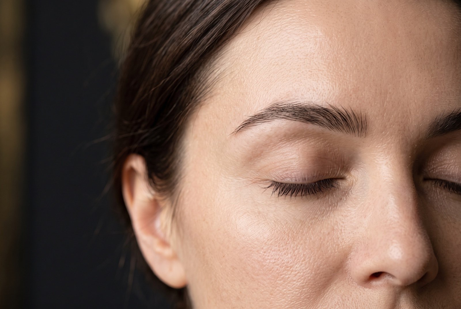 Natural eyebrows and closed eyes in soft light